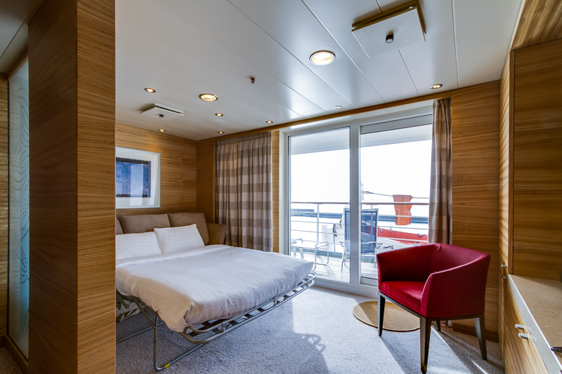 Cruise & Maritime Voyages Magellan Accommodation Deluxe Suite Sitting Area With Sofa Bed Down.jpg