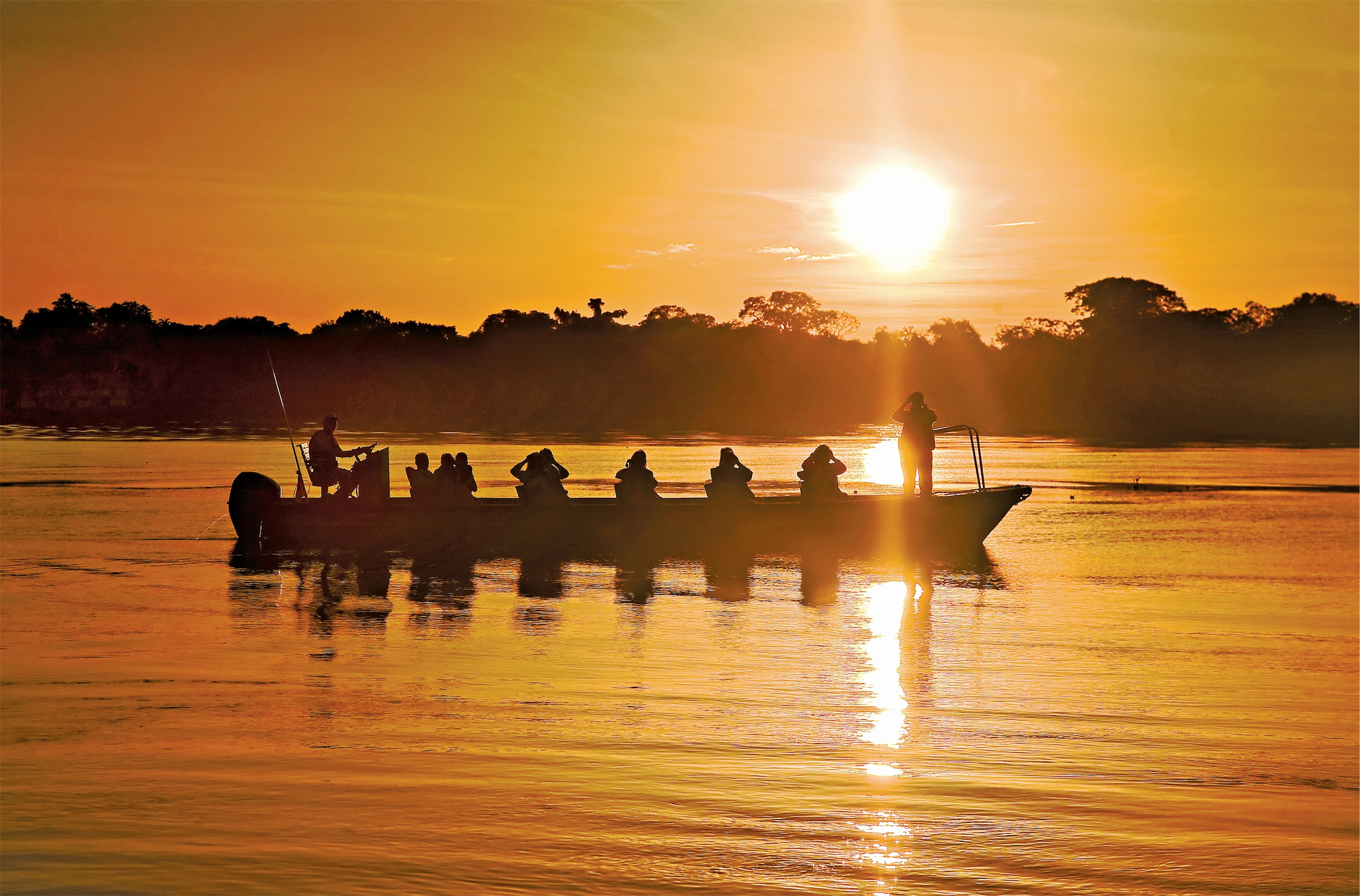 Lindblad Expeditions Delfin II Exterior Skiff Ride sunset.jpg