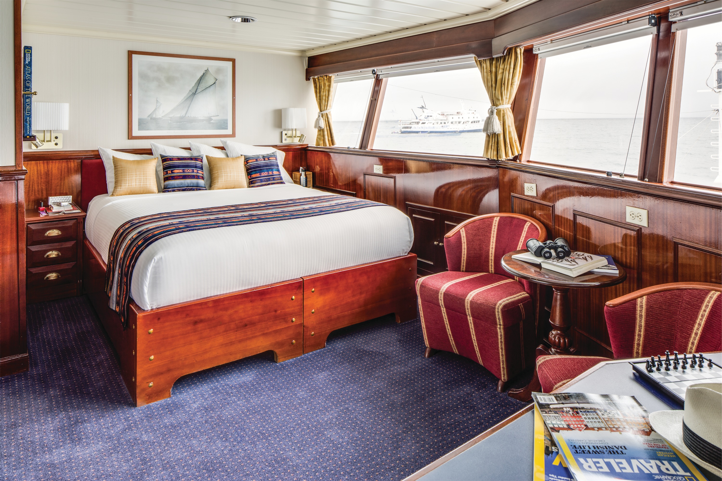 Lindblad Expeditions National Geographic Islander Accommodation Category 5 Bed & Living Room.jpg